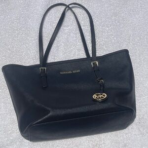 Michael Kors black leather with gold hardware shoulder bag.